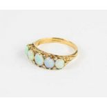 An 18ct gold and opal ring, the five oval opals in a pierced setting, size J/K, 3.3g.