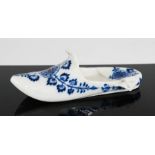 A Meissen blue and white pottery shoe, blue crossed sword marks and no. 62 to the base, 16cm long.