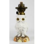 A Victorian ceramic paraffin lamp, in the form of an owl, blue mark to the base, 23cm high.