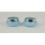 A pair of light blue glass and silver salts, with clear glass salt spoons.