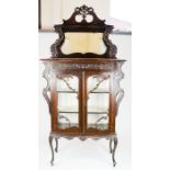 A late Edwardian mahogany glazed display cabinet, the pierced and carved crested top rail above a