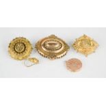 Three Victorian gilt metal brooches, pendant and an earring.