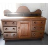 A Lincolnshire oak dresser, with shaped back, two cupboard doors flanking drawers.