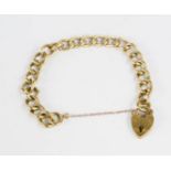 A 9ct gold chain link bracelet with heart form lock and safety chain, 12.4g.