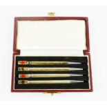 A set of four silver propelling pencils with deck of cards symbols to the tip, stamped Sterling
