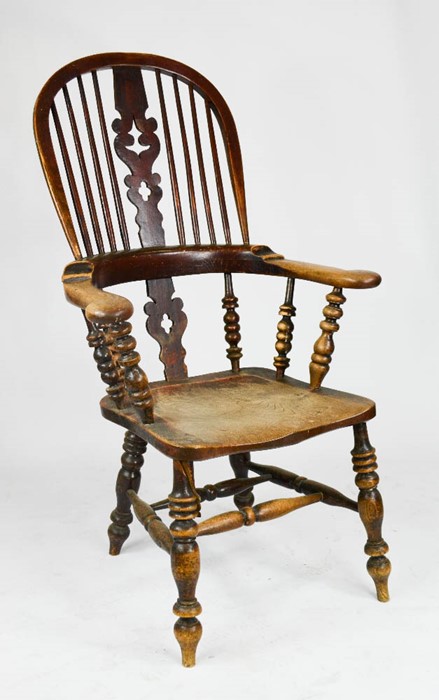 A 19th century elm Windsor armchair, with original residual dark red paint, with hoop back and