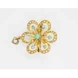 A 15ct gold and turquoise pendant, in the form of a flower set with seed pearls and turquoise