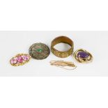 A yellow metal and amethyst brooch, a dress brooch with three pink stones, a bangle, filagree