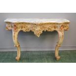 A French Regency period console table, carved with bold Rococo scrollwork, painted with detail,