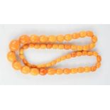 A cloudy amber necklace, composed of graduated oval beads.