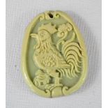 A Chinese carved pendant depicting a cockerel.