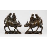 A pair of hardwood carved Chinese waterbuffalo being ridden by figures, inlaid with brass, 28cm