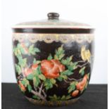 A Chinese jar and cover, with black ground, depicting fruits, 26cm high.