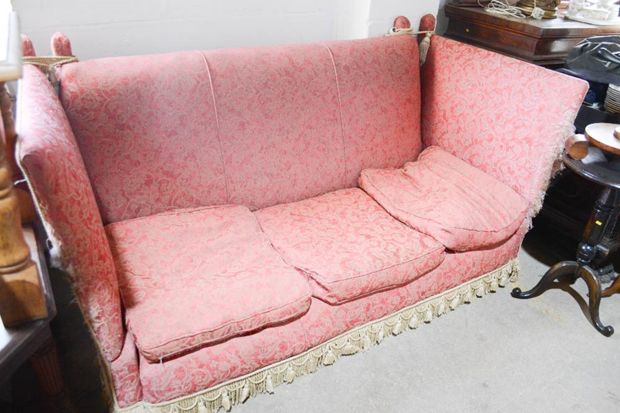 A 19th century Knowle settee, upholstered in pink silk, with three feather filled cushions.