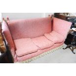 A 19th century Knowle settee, upholstered in pink silk, with three feather filled cushions.
