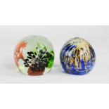 A Mdina glass paperweight and another example, 5½cm high.
