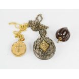 Two gilt metal lockets on chains, together with a nut pendant.
