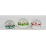 Three millefiori glass paperweights.