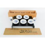 A set of five Japanese blue and white tea bowls, with wooden box.