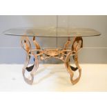 A copper patinated metal table, with smoky glass top.