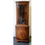 A mahogany glazed corner cabinet.