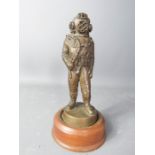 A bronzed figure of a deep sea diver.