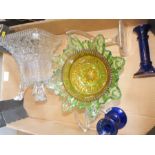 A group of glassware to include green bowl and blue candlesticks.