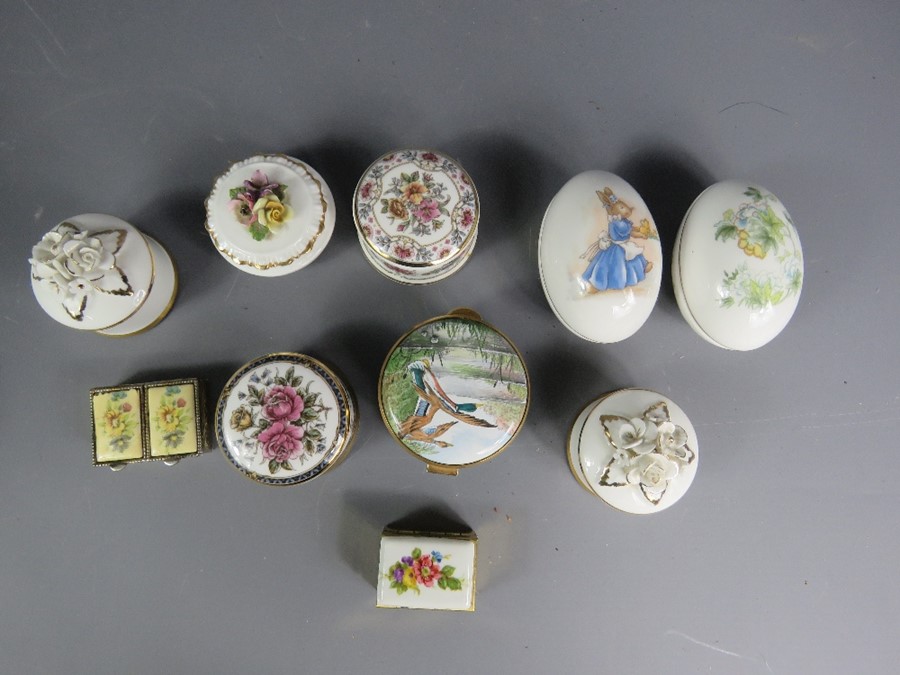 A large group of enamel pill boxes, mostly Del Prado.