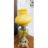 A paraffin lamp with a yellow glass shade, 52cm high.