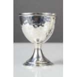 A Danish silver hammered egg cup, initialled with makers marks HE.