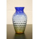An early 20th century blue and graduated orange vase with pressed body.