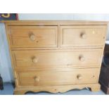 A pine chest of drawers, with two long and two short drawers.