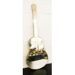 A Vintage wall mirror in the form of a guitar.