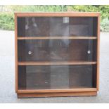 A bookcase with sliding glass doors, circa 1970.