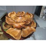 An American lazy susan, carved wooden petals in layers form the dishes, with rotating base.