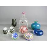 A group of five glass paperweights, two vases, and a pair of glass birds.