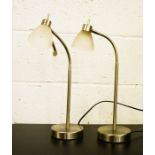 Two modern desk lamps, with opaque glass shades.