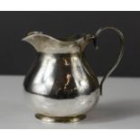 A silver gilt jug, hallmarked indistinctly.