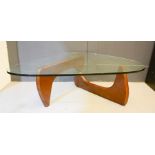 A mid-century glass top table, with shaped two part base, 41cm high.