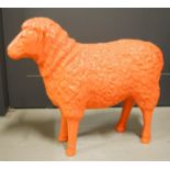 A lifesize model sheep, painted orange.