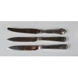Three silver handled knives.