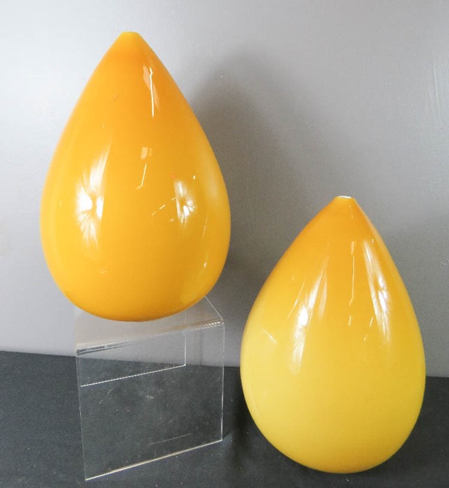 A pair of yellow glass pear drop form vases.