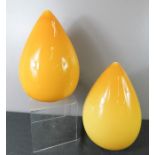 A pair of yellow glass pear drop form vases.