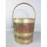 A brass bound coopered bucket.