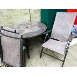 A glass topped garden table and matching chairs with umbrella and covers in original packaging.