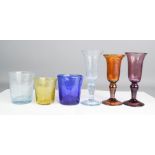 A group of hand made coloured glassware, with 'bubble' finish.