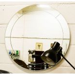 A circular glass wall mirror.