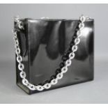 A Jane Shuton English patent black hand bag with chain straps.