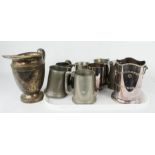 A group of pewter tankards together with a silver plated bottle stand, and jug.