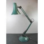 A green angle poise table lamp.